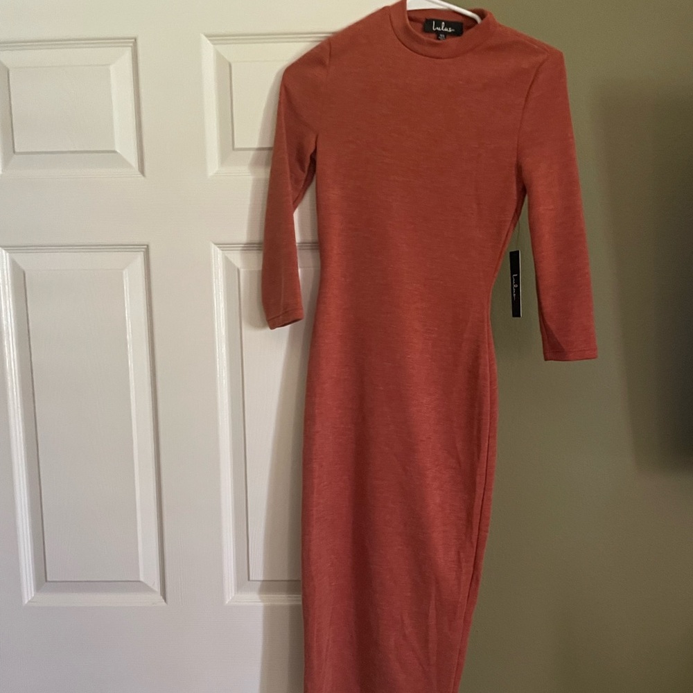 Orange polyester and spandex dress. 3/4 sleeve and midi length